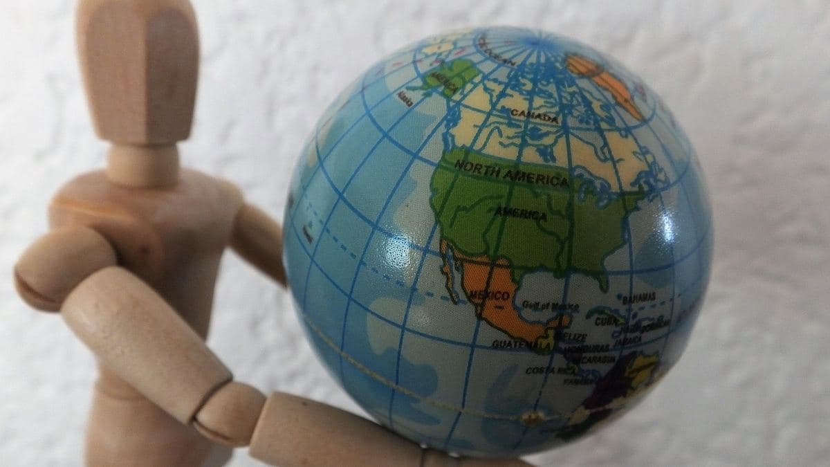 World map with a stylized globe figure symbolizing international trademark protection through the Madrid System