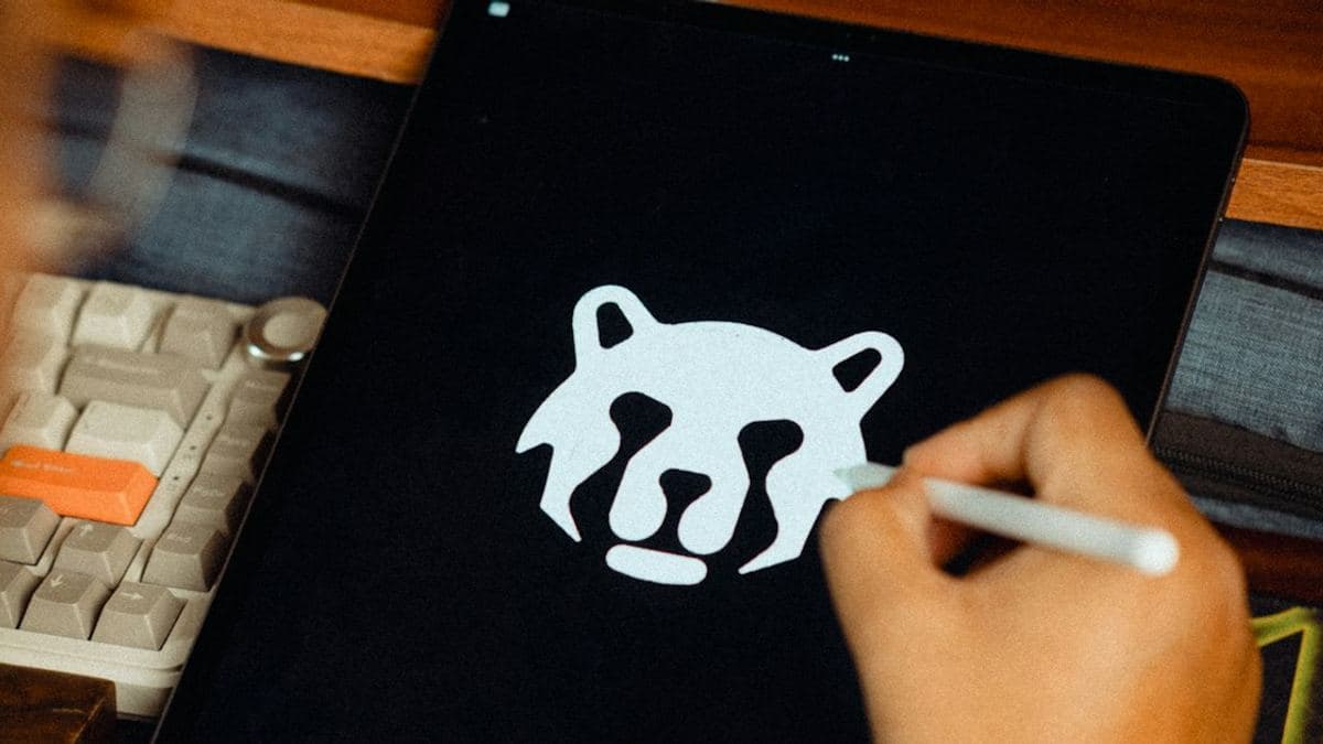 Designer sketching a logo on a tablet for a new brand logo